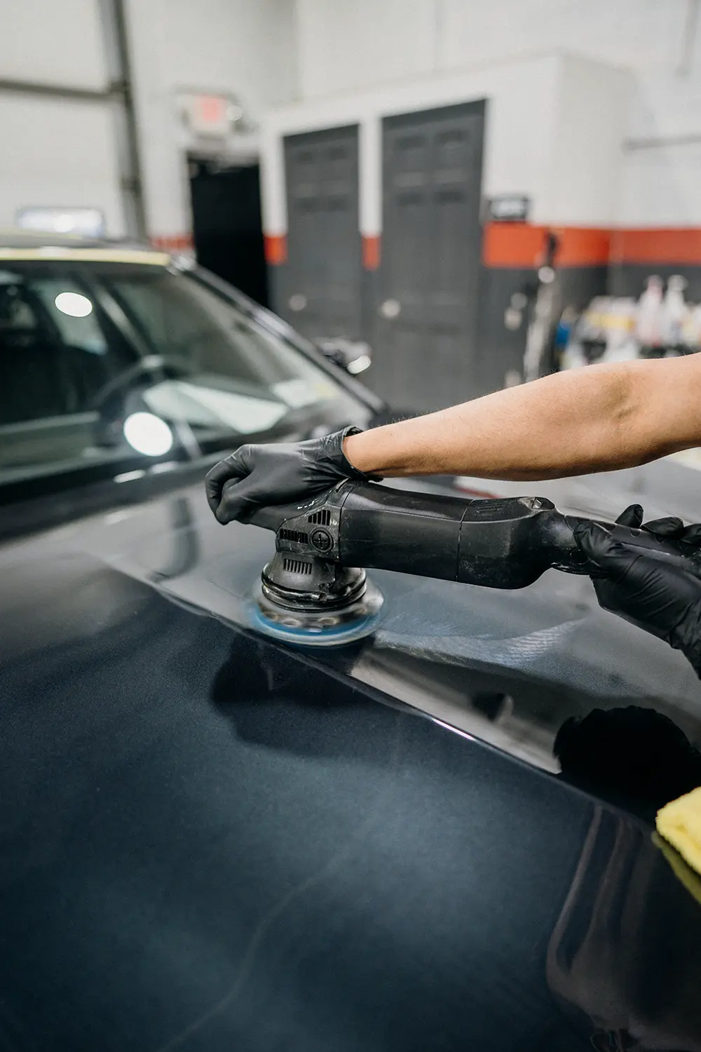 Machine paint correction being performed before paint protection film installation